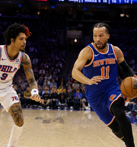 New York Knicks guard Jalen Brunson drives past Philadelphia 76ers forward Kelly Oubre Jr during an NBA game at Wells Fargo Center.