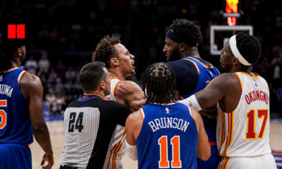 New York Knicks and Atlanta Hawks players in a heated on-court altercation during an NBA game while a referee tries to separate them.