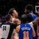 New York Knicks and Atlanta Hawks players in a heated on-court altercation during an NBA game while a referee tries to separate them.