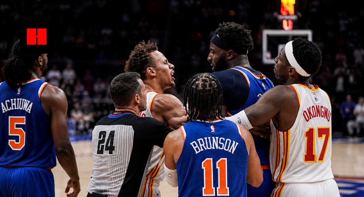 New York Knicks and Atlanta Hawks players in a heated on-court altercation during an NBA game while a referee tries to separate them.