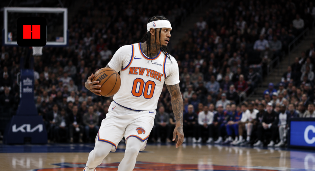 New York Knicks player dribbling the basketball during an NBA game captured from a dynamic side court angle inside the arena.