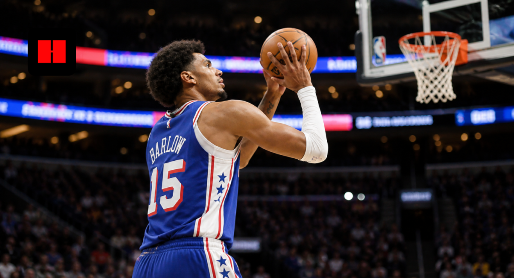 Philadelphia 76ers player attempting a close-range jump shot during an NBA game inside a packed arena